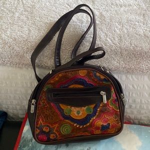 Crossbody/backpack tooling very nice feels like leather